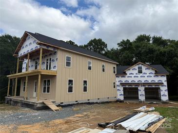 Two-story new construction with a two car garage and wood siding at 7217 Tesh Rd # 5, Monroe, NC 28110