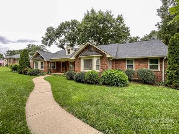 Charming brick home with a well-manicured lawn and winding walkway at 965 Hunting Ave, Lincolnton, NC 28092
