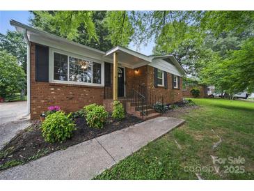 Charming brick home featuring manicured landscaping and inviting front entrance at 9818 Starwood Dr, Charlotte, NC 28215