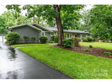 Charming single-story home featuring lush landscaping and a well-maintained front yard at 1035 15Th Nw Ave, Hickory, NC 28601