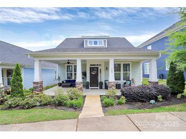 Charming single-story home with a covered front porch, stone accents, and landscaped yard at 109 Mac Aly, Cramerton, NC 28032
