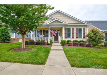Charming single-Gathering home featuring a well-manicured lawn, walkway, shrubs, and inviting front porch at 11607 Meetinghouse Dr, Cornelius, NC 28031