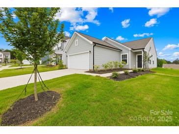 Charming home with a two-car garage, well-maintained lawn, and beautiful landscaping at 130 Slalom St, Statesville, NC 28677