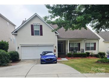 Charming two-story home with vinyl siding, manicured lawn, and an attached two-car garage at 2226 Elendil Ln, Charlotte, NC 28269