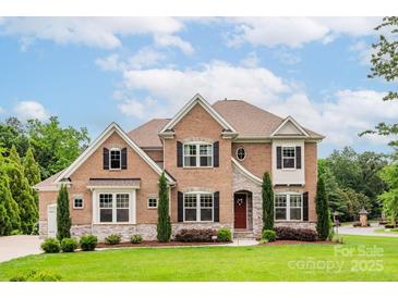 Attractive brick home featuring manicured landscaping, two stories, and a welcoming front entrance at 3009 Ocaso Ct, Matthews, NC 28104