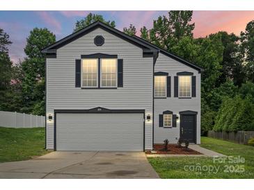 Charming two-story home featuring a gray exterior, black accents, and well-maintained landscaping at 3124 Pikes Peak Dr, Gastonia, NC 28052
