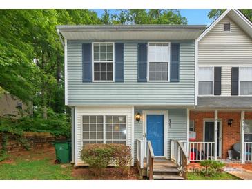 Charming two-story townhome with blue siding, shutters, and a bright blue front door at 6401 Windsor Gate Ln, Charlotte, NC 28215
