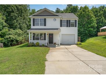 Charming two-story home with a welcoming front porch and well-maintained landscaping and long driveway at 8524 Emerald Fern Way, Charlotte, NC 28214