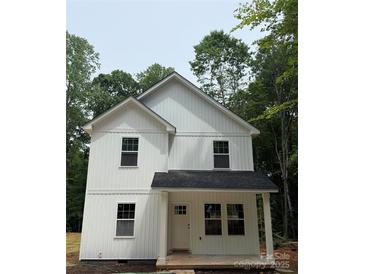 Charming new construction two-story home featuring white siding and a welcoming front porch in a wooded neighborhood at 1723 Rhyneland Cir, Gastonia, NC 28054