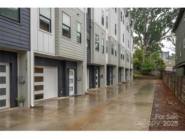 A row of modern townhomes featuring individual garages and contemporary design, set in a desirable neighborhood at 2011 Hamorton Pl, Charlotte, NC 28205