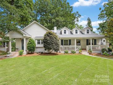 Charming white-painted brick home with a welcoming front porch and lush green lawn at 2112 Chatham Ave, Charlotte, NC 28205