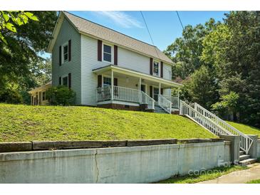 Charming two-story home featuring a welcoming front porch and beautiful lawn at 238 N Depot St, Albemarle, NC 28001