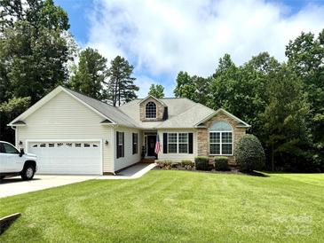 Charming single-story home featuring stone accents, manicured lawn, and attached two-car garage at 3110 Richards Way Dr, Rock Hill, SC 29732