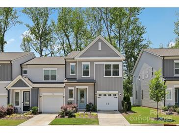Charming two-story townhome with a well-manicured lawn and attached one car garage at 5324 Somerset Hill Ln, Charlotte, NC 28269