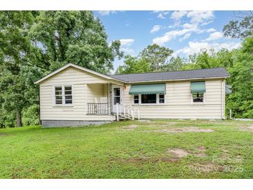Charming single-story home with a welcoming front porch and lush green lawn at 8334 Oaktree Rd, Sharon, SC 29742