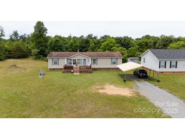 Charming single-Gathering home with a welcoming front porch and a convenient carport at 1007 W Cabaniss Rd, Shelby, NC 28150
