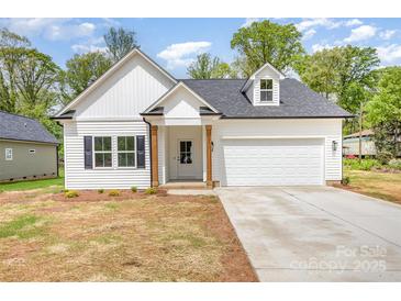 Charming new construction home with white siding, black shutters and a two-car garage at 120 Autumn Blaze Rd, China Grove, NC 28023
