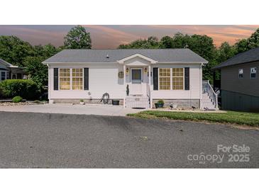 Charming one-story home featuring a welcoming front entrance and manicured landscaping at 161 Badin Lake Cir, New London, NC 28127