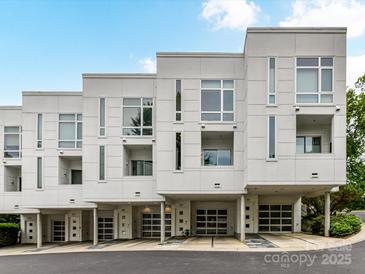 Modern townhome featuring a white exterior, covered parking, and contemporary design at 314 Viburnum Way Ct, Charlotte, NC 28208