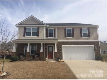 Charming two-story home featuring a two-car garage and welcoming front porch at 5008 Social Cir, Fort Mill, SC 29707