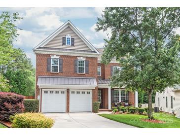 Charming brick two-story home with a manicured front yard and a two car garage at 8115 Wilburn Ct, Charlotte, NC 28277