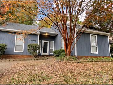 Charming single-story home featuring mature landscaping and a freshly painted exterior, creating an inviting curb appeal at 11421 Kingfisher Dr, Charlotte, NC 28226