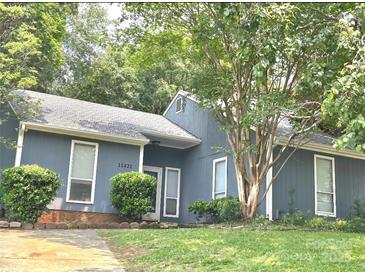 Charming single-story home with a well-maintained lawn and mature trees for added curb appeal at 11421 Kingfisher Dr, Charlotte, NC 28226