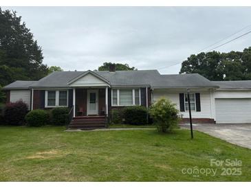 Charming ranch-style home featuring a brick facade, white siding, green lawn, and mature trees at 1292 Longview Rd, Rock Hill, SC 29732