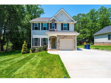 Charming two-story home features a well-manicured lawn, brick accents, and an attached two-car garage, perfect for Gathering living at 2045 13Th Ne St # 3, Hickory, NC 28601