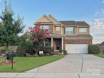 Charming brick home with a well-manicured lawn and beautiful landscaping at 3416 Yarmouth Ln, Gastonia, NC 28056