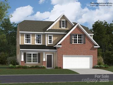 Charming two-story home featuring a brick and siding facade with a two-car garage and well-manicured lawn at 4247 Skyboat Cir, Fort Mill, SC 29715