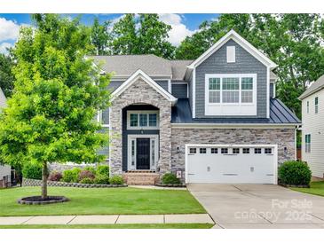 Charming two-story home featuring stone accents, a manicured lawn, and a two-car garage at 645 Brookhaven Dr, Fort Mill, SC 29708