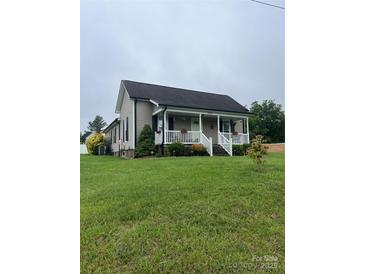 Charming single-Gathering home with a covered front porch and well-manicured lawn at 8720 Lee St, Mount Pleasant, NC 28124