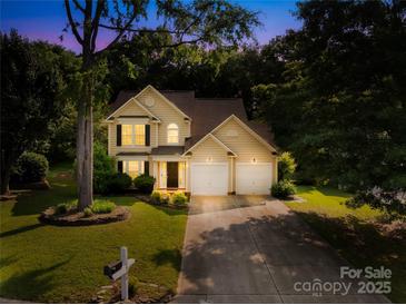 Charming two-story home with a well-maintained lawn, mature trees, and an inviting entrance at 10908 Delsing Ct, Charlotte, NC 28214