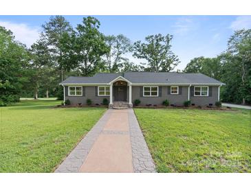 Charming single-story home with a well-manicured lawn and inviting walkway at 120 Pinewood Ln, Rock Hill, SC 29730