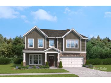 Charming two-story home with a stone-accented garage and a beautifully landscaped front yard at 308 Balboa St, Matthews, NC 28104
