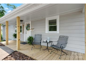 Cozy front porch with seating, plants and decorative wreath on front door of charming home at 73 20Th Sw Ave, Hickory, NC 28602