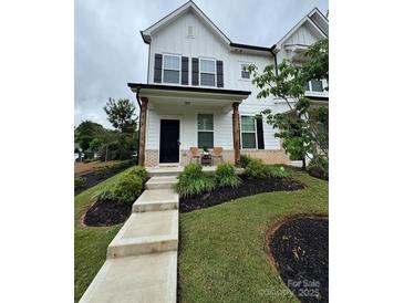 Charming two-story home with a welcoming front porch, well-manicured landscaping, and a freshly painted white exterior at 734 Herlong Ave, Rock Hill, SC 29732