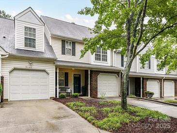 Charming townhome featuring a one-car garage, landscaped front yard, and a welcoming front porch at 9530 Elizabeth Townes Ln, Charlotte, NC 28277