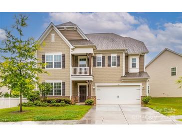 Charming two-story home with a welcoming front porch, manicured lawn, and attached two-car garage at 150 W Morehouse Ave, Mooresville, NC 28117