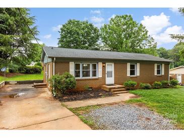Charming brick home featuring a well-maintained lawn and inviting front entrance at 1606 Northwoods Dr, Kings Mountain, NC 28086