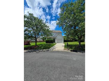 Charming two-story home featuring a well-manicured lawn, a single-car garage, and mature trees at 2924 Sedona Pl, Fort Mill, SC 29708