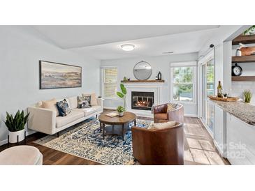 Inviting living room features a cozy fireplace, stylish furniture, and bright natural light at 3308 Selwyn Farms Ln # 5, Charlotte, NC 28209
