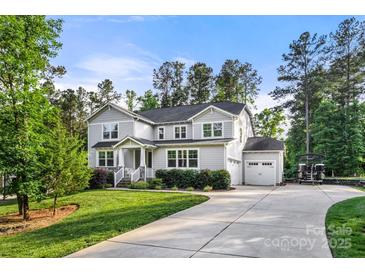 Charming two-story home with a well-manicured lawn, attached garage, and wide driveway at 4189 Island Fox Ln, Denver, NC 28037
