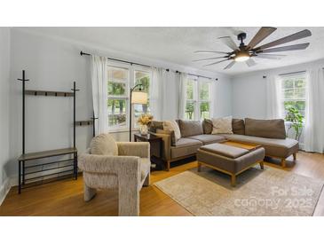Bright living room with ceiling fan, neutral walls, and comfortable seating, creating a cozy atmosphere at 4230 Train Chaser Pl, Indian Land, SC 29707