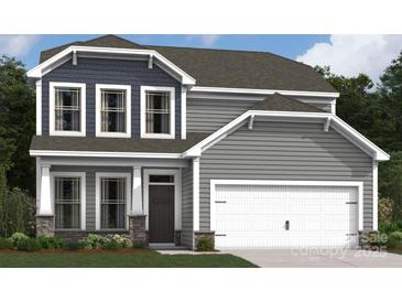 Charming two-story home with gray siding, stone accents, a two-car garage and a manicured lawn at 8614 Acadia Pkwy, Sherrills Ford, NC 28673