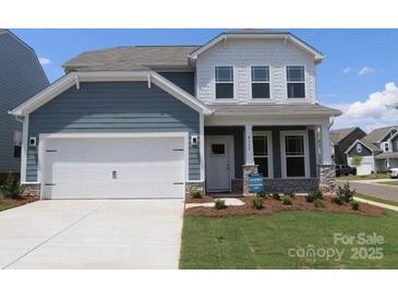 Charming two-story home featuring a pristine white garage door and inviting covered porch at 8614 Acadia Pkwy, Sherrills Ford, NC 28673