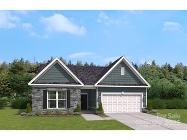 Charming home featuring stone accents, a two-car garage, and professionally landscaped front yard at 889 Exeter Dr, Sherrills Ford, NC 28673