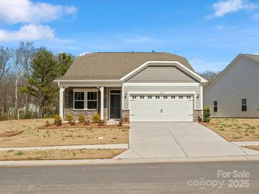 Charming single-story home featuring stone accents, neutral siding, and an attached two-car garage at 1074 Bull Dog Ln, Wingate, NC 28174
