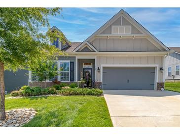 Charming front exterior of home featuring manicured lawn, tasteful landscaping, and a welcoming facade at 128 Asher Ln, Mooresville, NC 28115